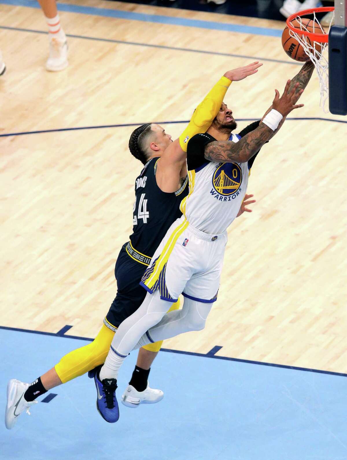 Gary Payton II (0) is fouled by Memphis’ Dillon Brooks (24) in Game 2 of the Western Conference semifinals on May 3. Payton fractured his left elbow on the play; Brooks was assessed a flagrant-2 foul and ejected from the game.