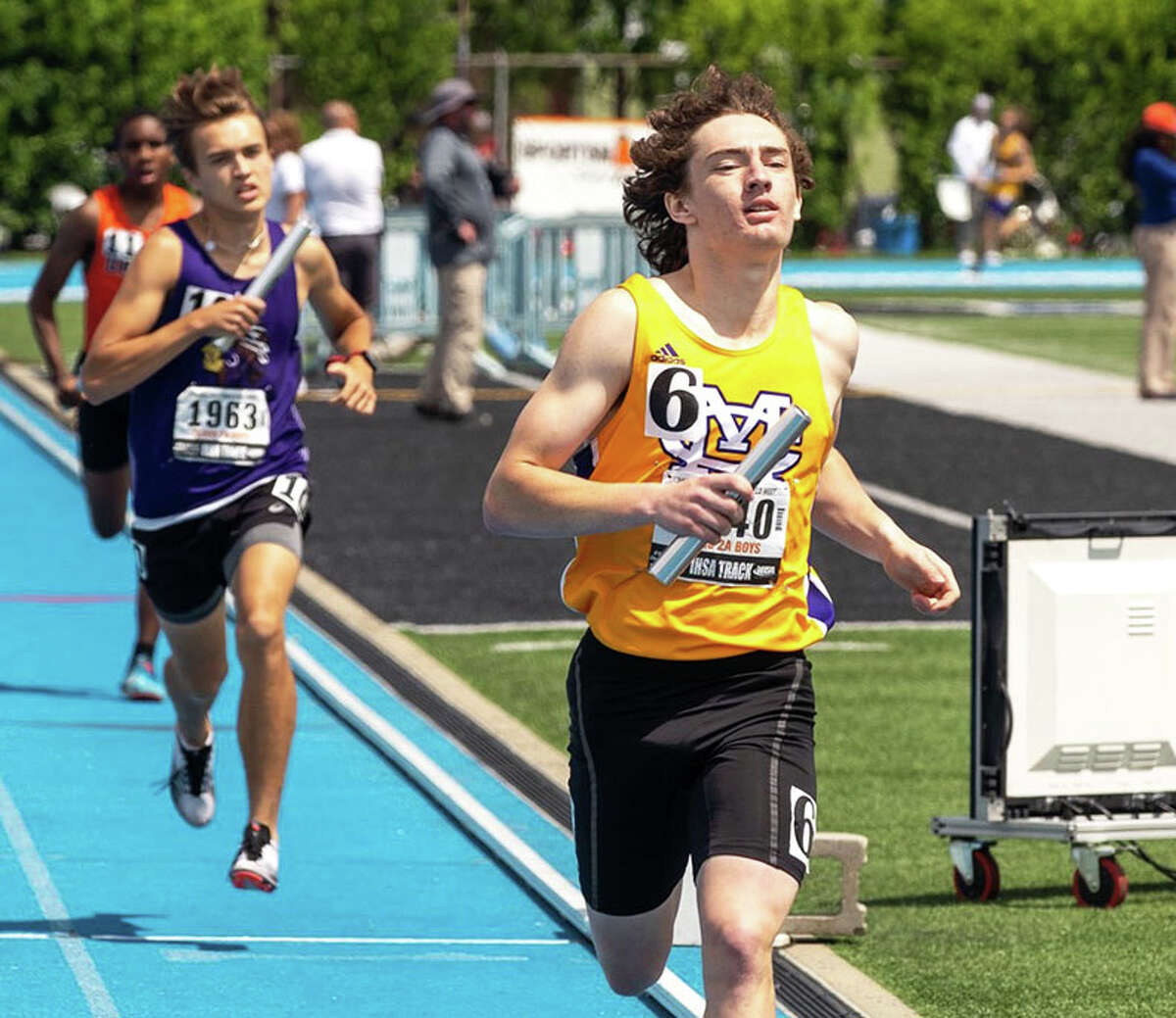 CM's Aslan Henderson (right) brings the Eagles' 4x800 relay home in eighth place ahead of Mascoutah on Saturday at the Class 2A state track meet in Charleston.