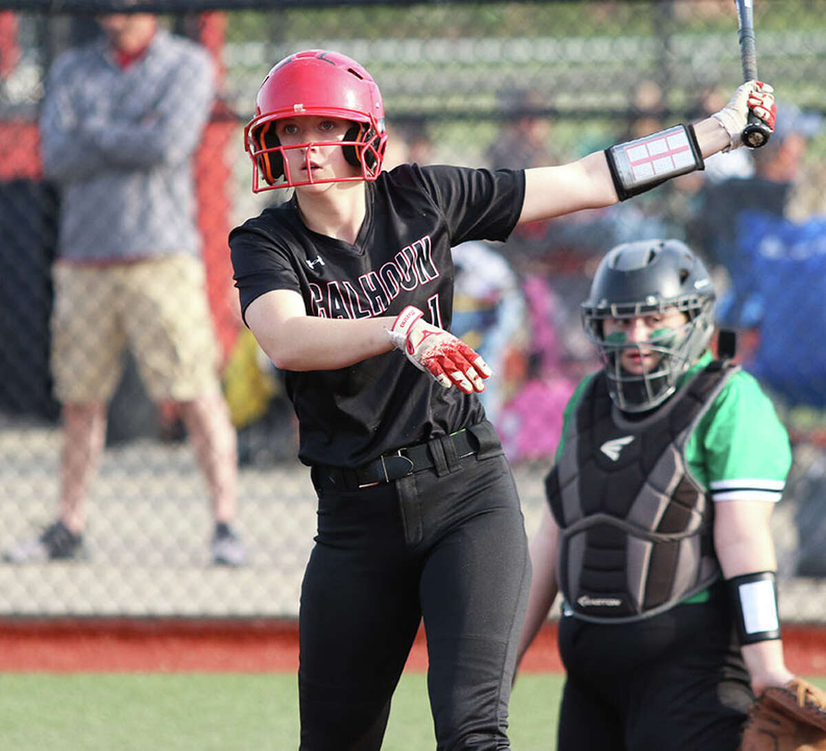 Calhoun's Lila Simon (left) looks to her coach before getting in the batter's box against Carrollton in a game earlier this season in Jacksonville. On Saturday, Simon hit a triple and scored the game-winning run to beat Marissa in a Class 1A sectional title game.