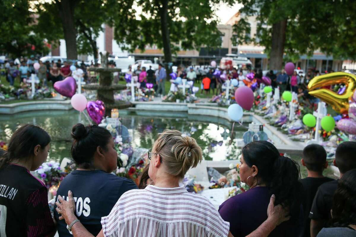 People visit the Town Square, the site of a memorial for the victims of the mass shooting at Robb Elementary School, on Friday, May 27, 2022, in Uvalde, Texas.