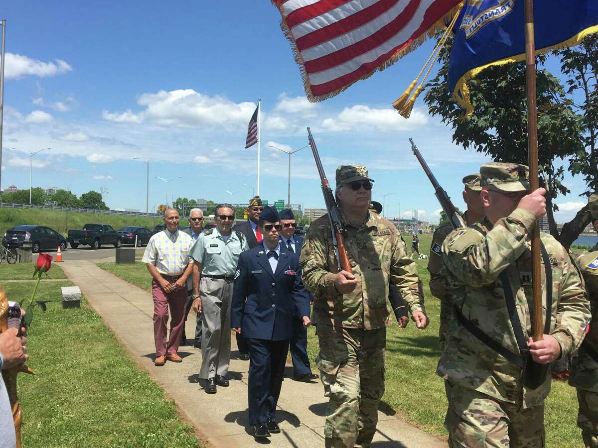 New Haven veterans and officials approach the Vietnam Memorial at Vietnam Veterans Memorial Park at Long Wharf for the first of New Haven’s two Memorial Day observances on Sunday, May 29, 2022.
