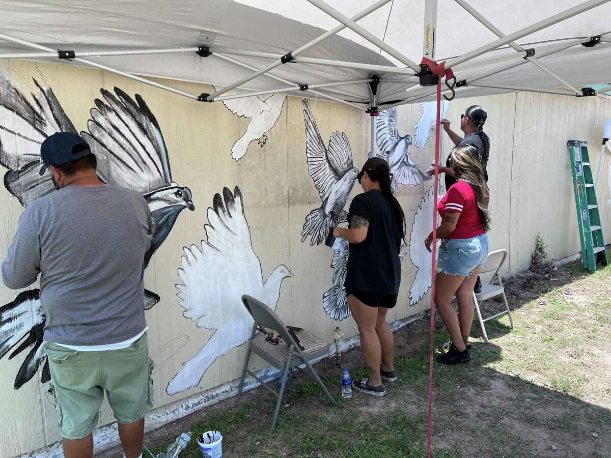 Artist Michael Sanchez (from left), Alina DeLeon, Mariah Hinojosa and Yanira Castillo work on a mural they are creating dedicated to those who were killed during or died in the aftermath of the Uvalde shootings.