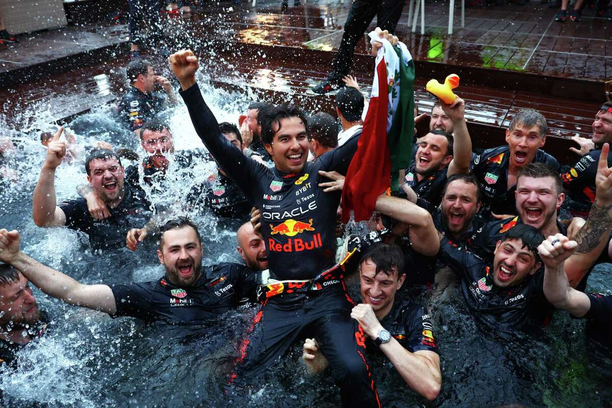 Sergio Perez of Mexico and the Red Bull team his win by jumping into the pool after the Grand Prix of Monaco.