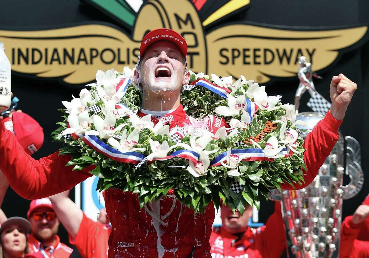 INDIANAPOLIS, INDIANA - MAY 29: Marcus Ericsson of Sweden, driver of the #5 Chip Ganassi Racing Honda, celebrates in Victory Lane by pouring milk on his head after winning the 106th Running of The Indianapolis 500 at Indianapolis Motor Speedway on May 29, 2022 in Indianapolis, Indiana. (Photo by Jamie Squire/Getty Images)