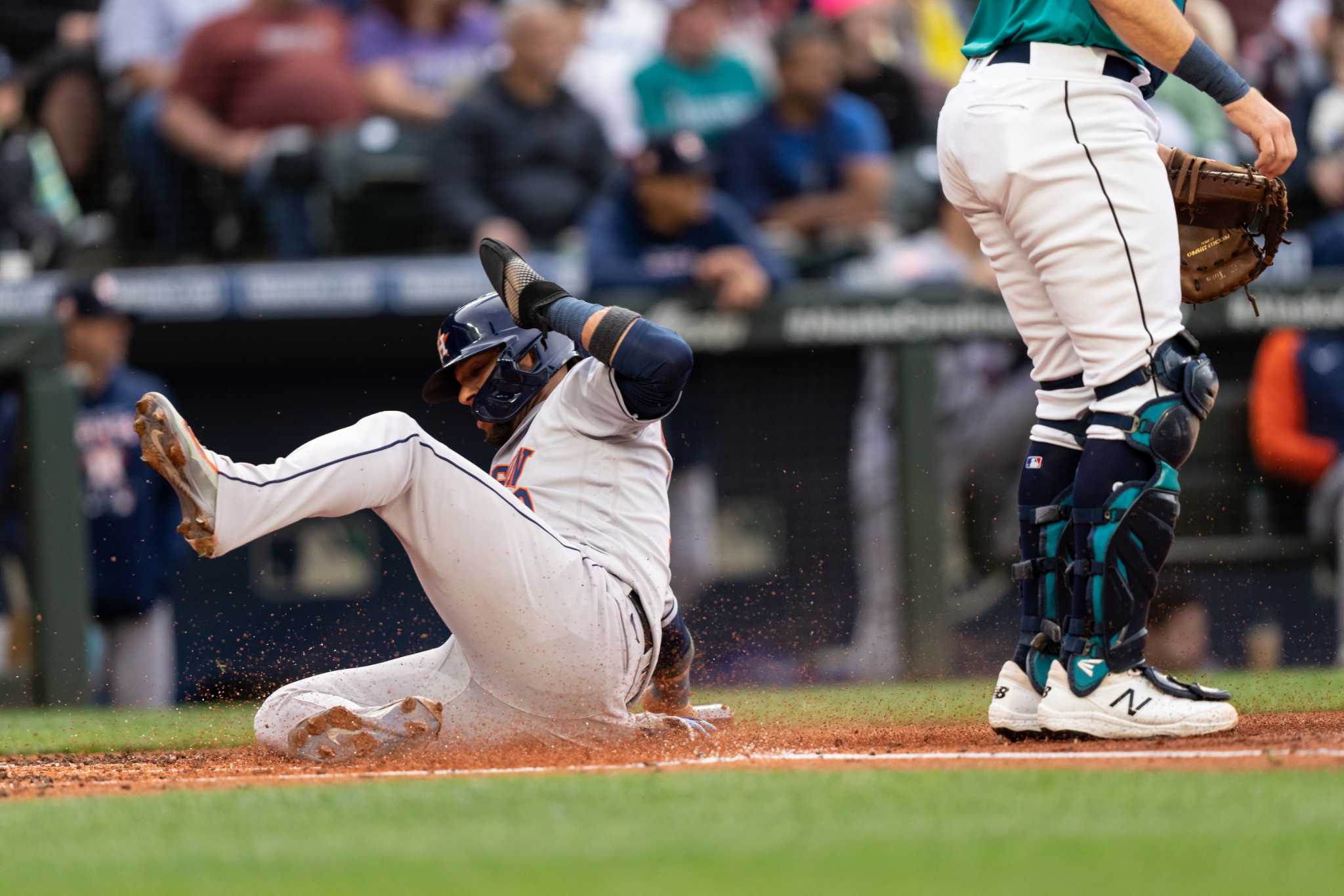 Seattle Mariners' Luis Torrens reacts after he slid safely home to score on  a RBI single hit by Ty France during the sixth inning of a baseball game  against the Houston Astros