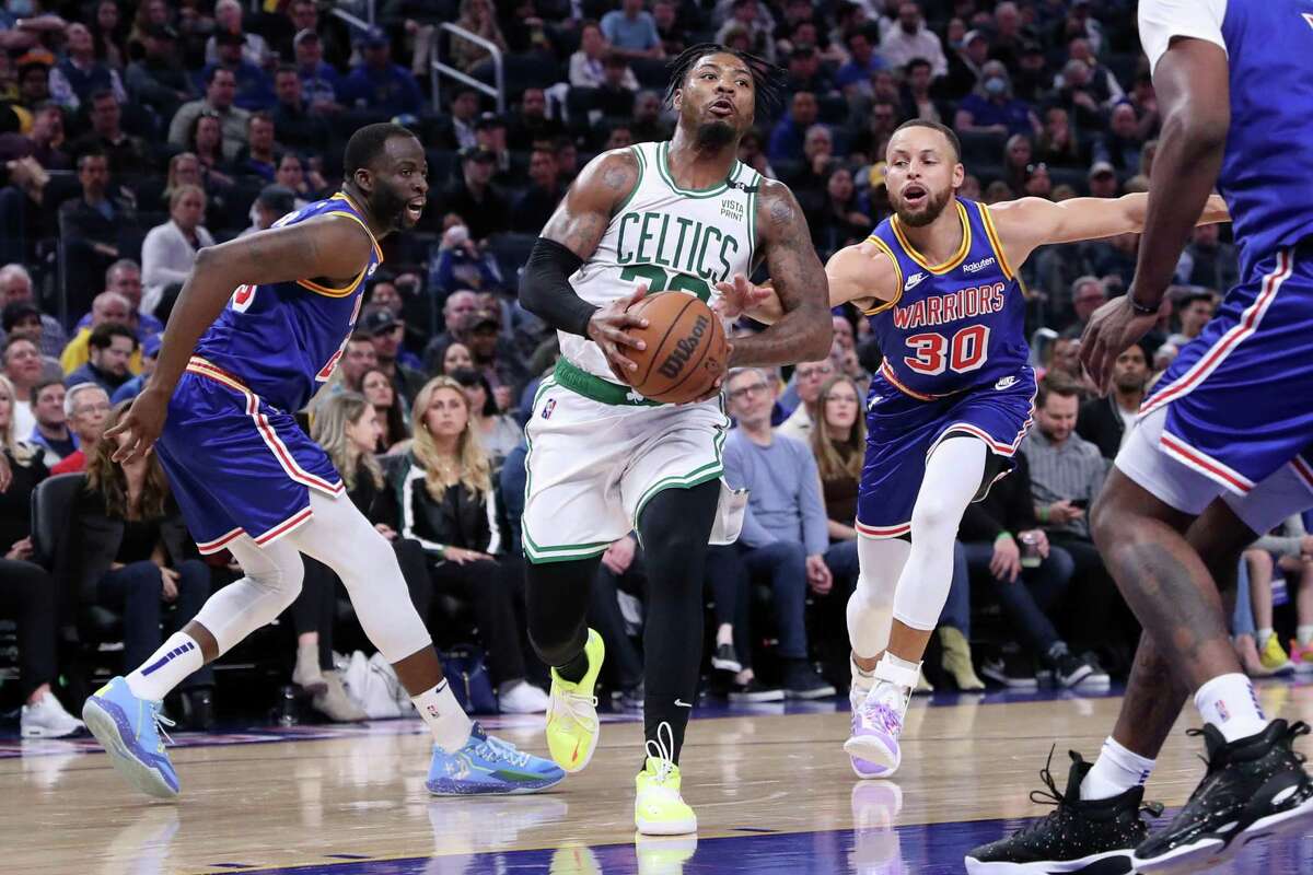 Boston Celtics' Marcus Smart gets past Golden State Warriors' Stephen Curry and Draymond Green in 2nd quarter during NBA game at Chase Center in San Francisco, Calif., on Wednesday, March 16, 2022.