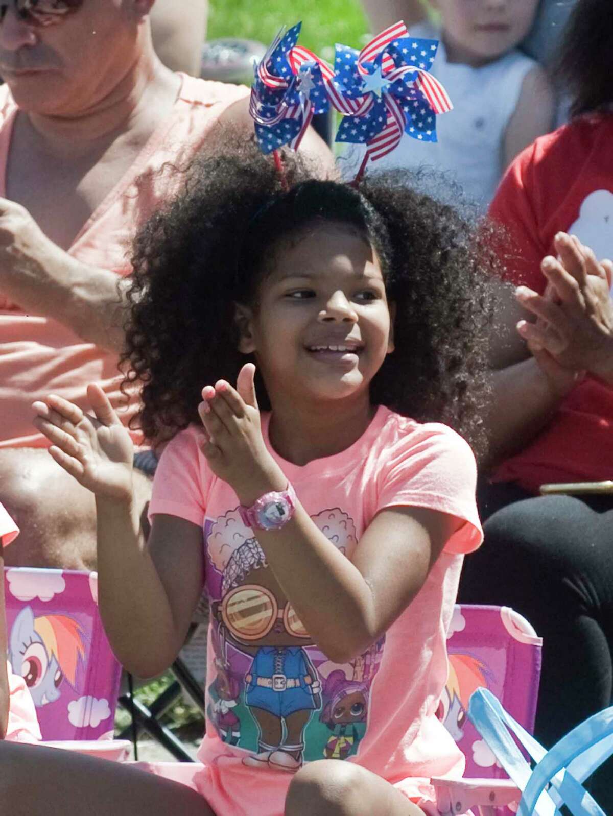 Chanel Thompson, 8 of Norwalk, enjoying the marchers on East Avenue in the annual Memorial Day Parade. Monday, May 30, 2022