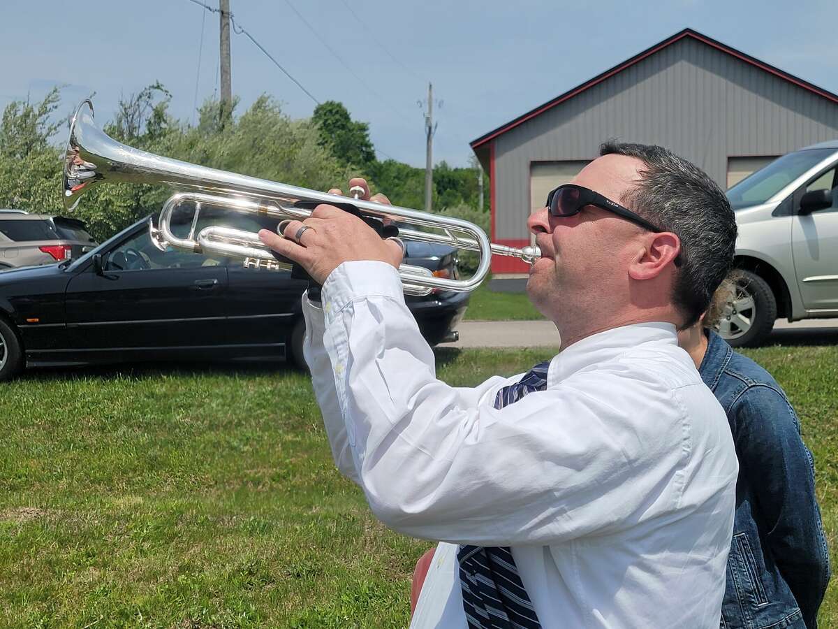 Ben MacRae plays "Taps" at the remembrance ceremony at the Benzie County Veterans' Memorial. McRae has been playing "Taps" at Memorial Day ceremonies for over 30 years. 