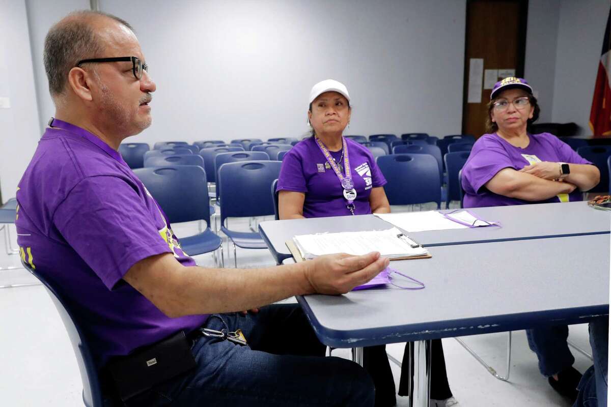 Unionized janitorial workers,from left, Victor Henandez, Maria Sanchez and Mercedes Herrera talks about their concerns and issues before a meeting of other SEIU Texas members, a Houston janitors union, at the IBEW Union Hall Saturday, May 28, 2022 in Houston, TX.