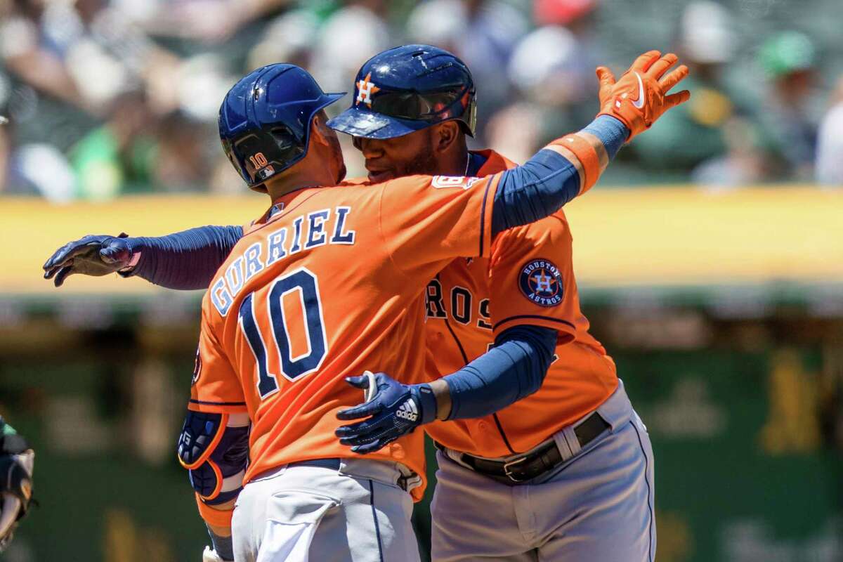Houston Astros' Yordan Alvarez, right, celebrates with Yuli Gurriel (10) after hitting a solo home run against the Oakland Athletics during the fourth inning of a baseball game in Oakland, Calif., Monday, May 30, 2022. (AP Photo/John Hefti)