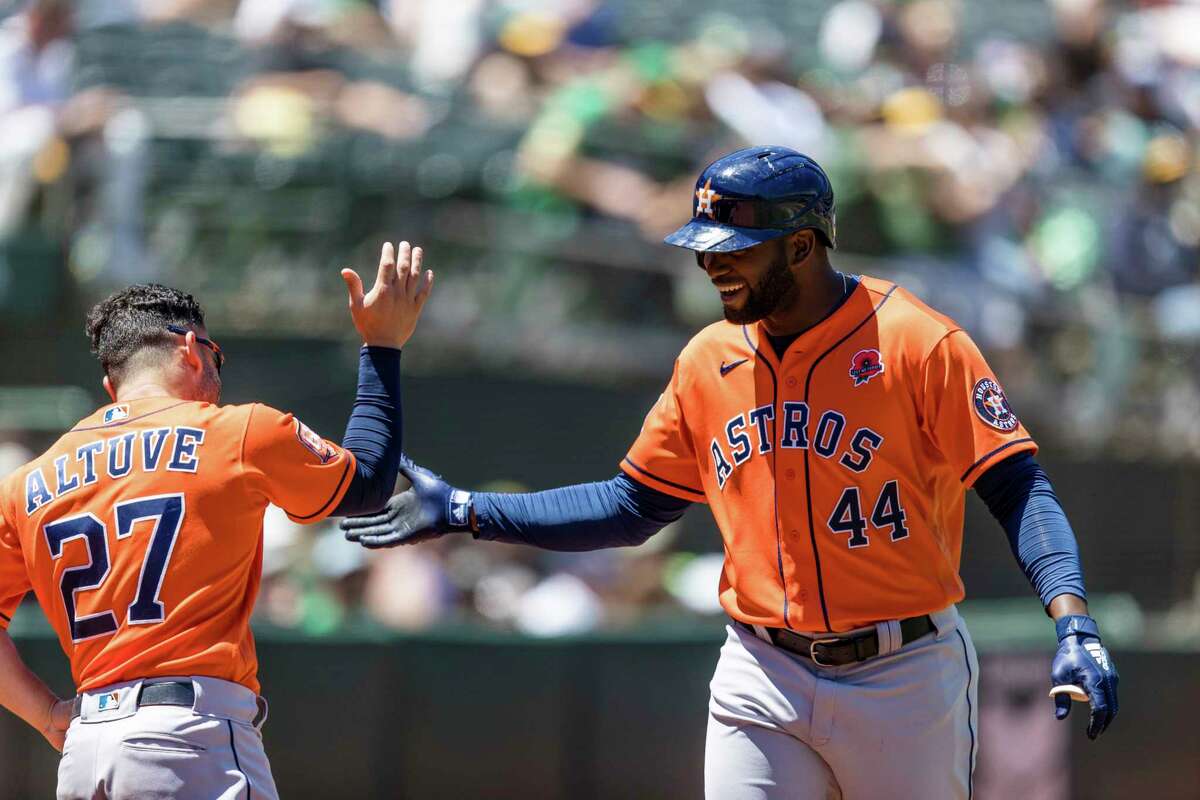 Houston Astros' Yordan Alvarez (44) celebrates with Jose Altuve (27) after hitting a solo home run against the Oakland Athletics during the fourth inning of a baseball game in Oakland, Calif., Monday, May 30, 2022. (AP Photo/John Hefti)