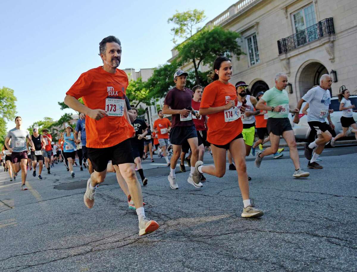 Above, Greenwich’s Richard Dupont and Ava DuPont run in the Jim Fixx Memorial Day 5K Run in Greenwich on Monday. More than 200 runners competed in the 5K with Cos Cob's Asher Beck finishing first overall and Greenwich's Kelly Annunziato finishing first among women.
