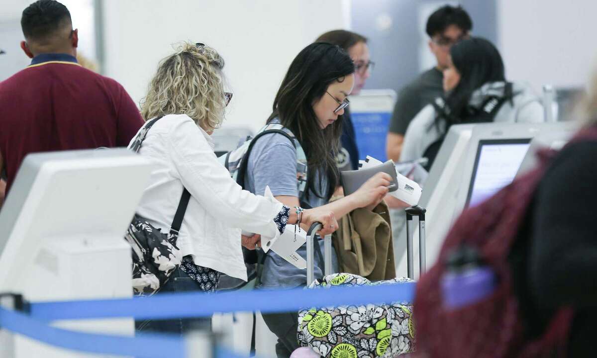 Travelers check into their flights at George Bush Intercontinental Airport on Monday, May 30, 2022 in Houston. According to AAA more than 39 million people are expected to travel 50 miles or more from home during the 2022 Memorial Day holiday weekend and airlines were expecting numbers of travelers that rivaled pre-pandemic levels.