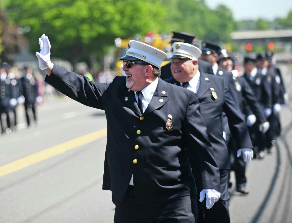 Noroton Fire Department Vice President Bob Buch Sr. marches with other first responders in the Darien Memorial Day Parade on Monday. Hundreds of participants marched from the Goodwives Shopping Center to the Spring Grove Veterans Cemetery, where a ceremony was held to honor the veterans whose lives were lost in battle. More photos, XX