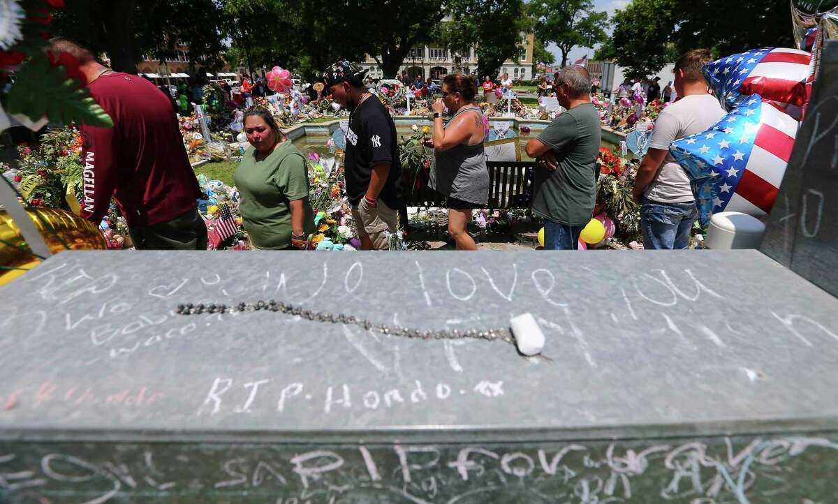 People make their way around a memorial at Uvalde Town Square on Monday, May 30, 2022. Visitations for two of the students who perished in the Robb Elementary School shootings also occurred on Monday.