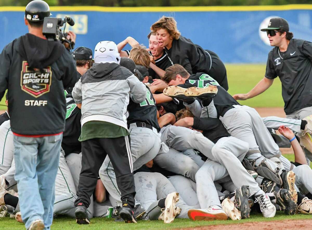 De La Salle-Concord players pile on each other after the Spartans defeated East Bay Athletic League rival Foothill-Pleasanton for the North Coast Section Division I title on Friday.