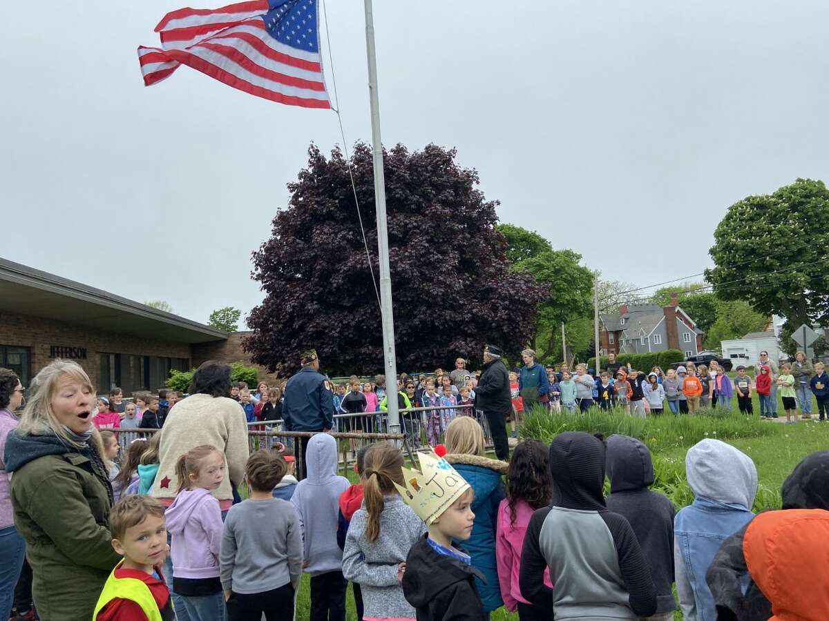 Students of Jefferson Elementary School, in Manistee, watch Friday as  members of VFW Post No. 4499 conduct a flag raising ceremony.