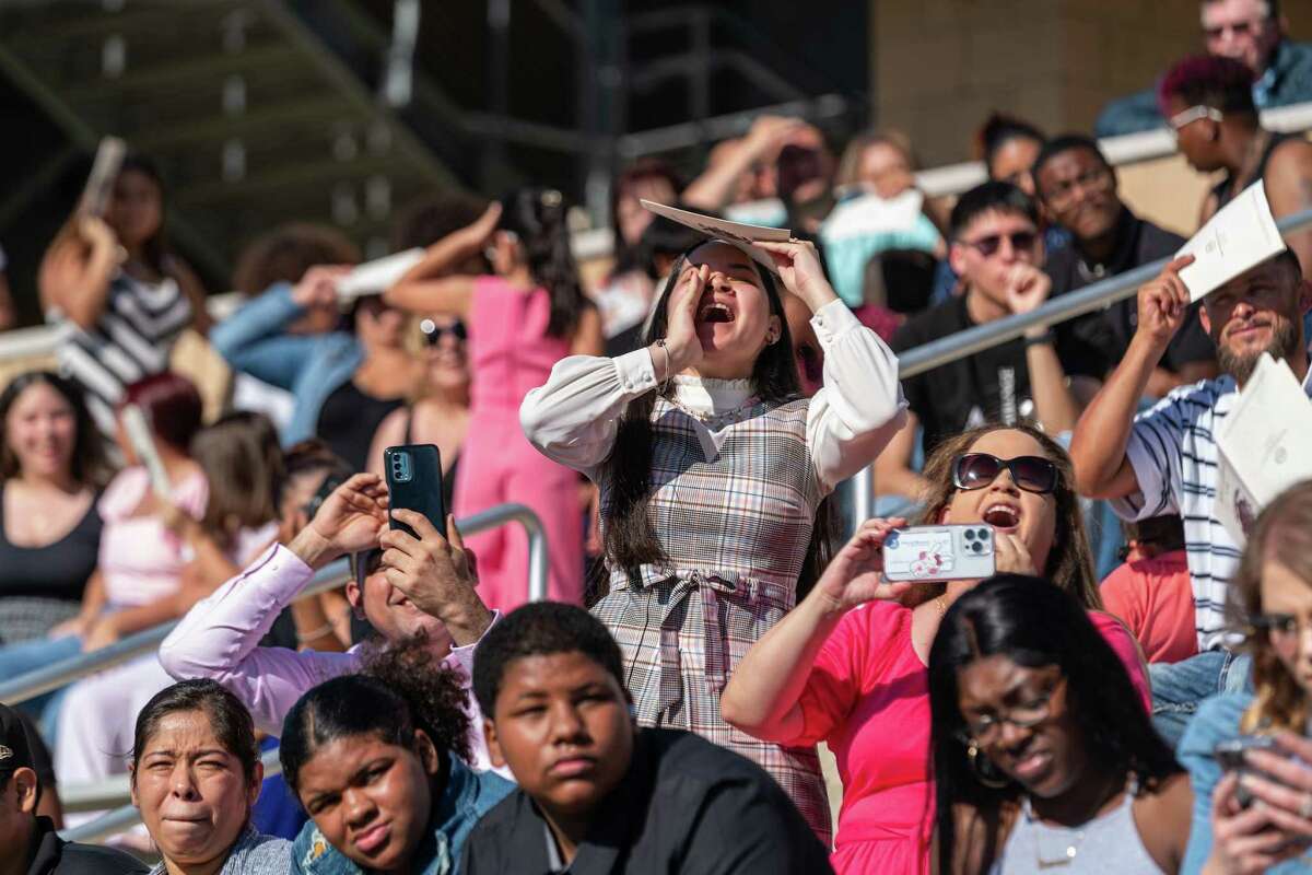 Friends and family cheer for Spring Early College Academy graduating seniors from the stands at Planet Ford Stadium during a ceremony Thursday, May 26.