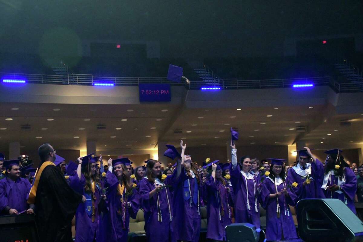 Tomball Star Academy graduates toss their caps during their ceremony on May 26 at Champion Forest Baptist Church.