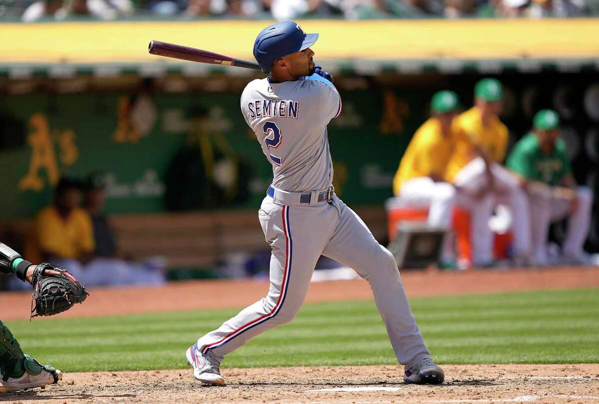 Marcus Semien #2 of the Texas Rangers hits a grand slam home run against the Oakland Athletics in the top of the fifth inning at RingCentral Coliseum on May 28, 2022 in Oakland, California.