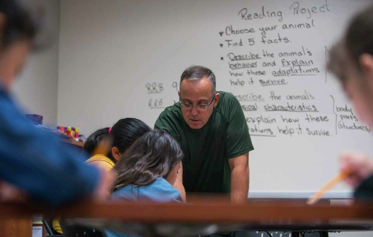 Manuel Gonzalez teaches reading to fourth graders during summer school classes at Michael R. Null Middle School in Sheldon ISD, Thursday, June 20, 2019.