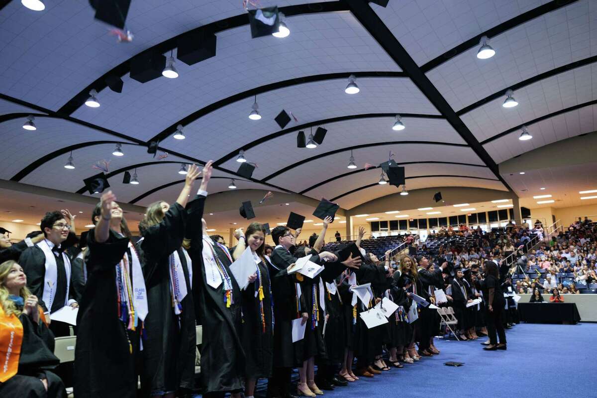 The members of the Westchester Academy for International Studies class of 2022 toss their caps in the air at the conclusion of their graduation ceremony at Don Coleman Community Coliseum on May 27