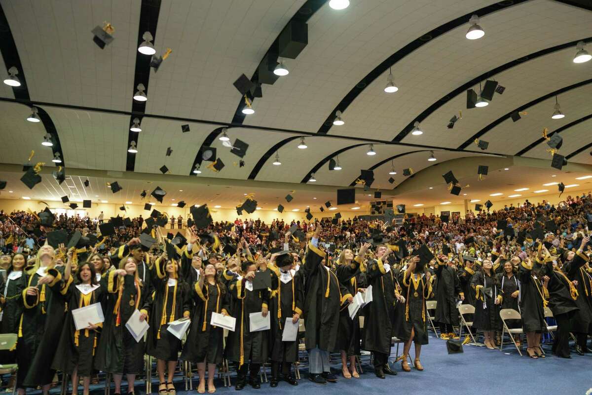 The members of the Spring Woods High School class of 2022 toss their caps in the air at the conclusion of their graduation ceremony at Don Coleman Community Coliseum on May 28