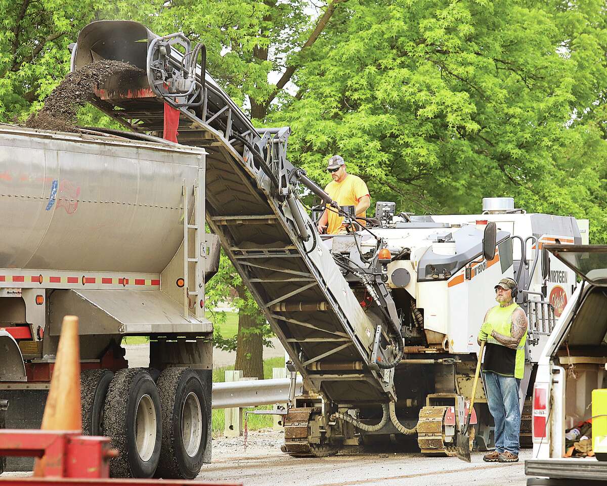 John Badman|The Telegraph A road milling machine tears off the top layer of asphalt Tuesday morning in the eastbound lanes of the Homer Adams Parkway near its intersection with Godfrey Road.