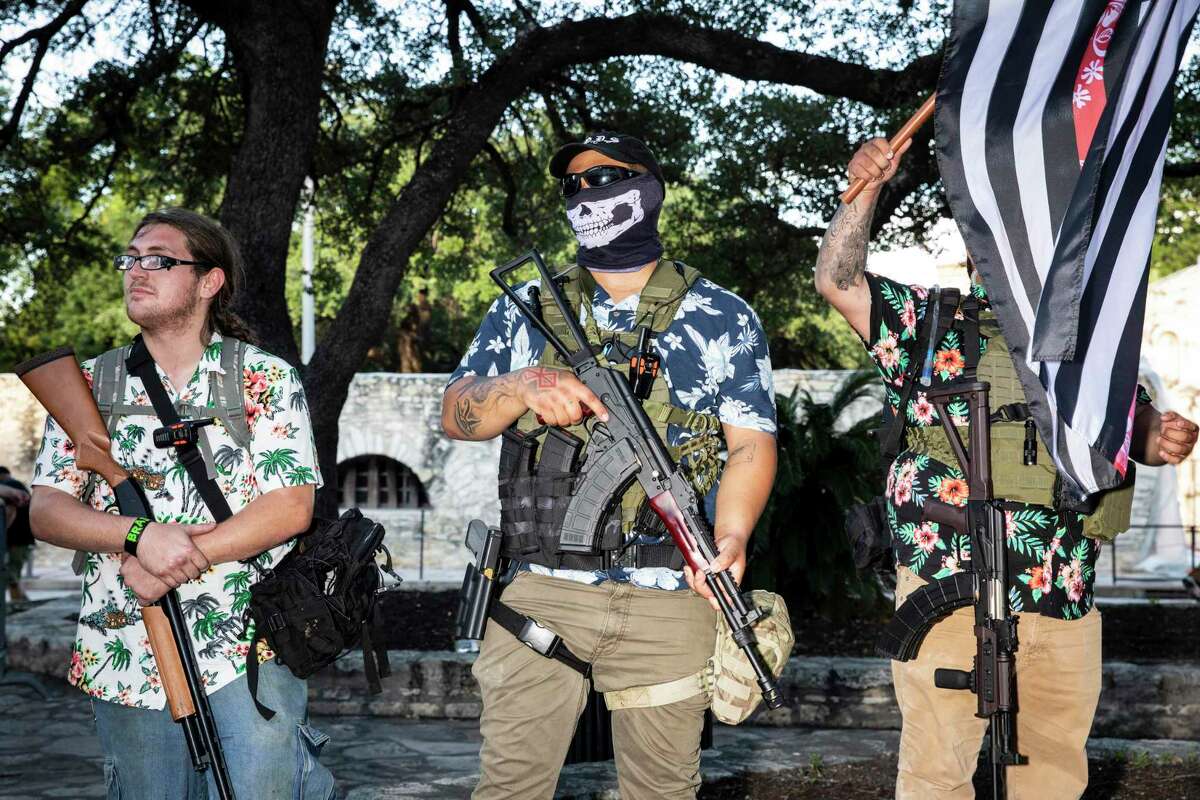 Military-style groups brandished firearms to protect the Cenotaph in front of the Alamo in downtown San Antonio, Texas, U.S. on Saturday, May 30, 2020. Three men shown here are wearing the signature Hawaiian shirts worn by the extremist group the Boogaloo Boys. People took to the streets of San Antonio to protest the killing of George Floyd in Minnesota while he was in police custody.