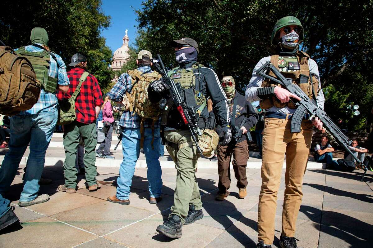 Armed groups hold a rally in front of a closed Texas State Capitol in Austin, Texas, on Jan. 17, 2021, during a nationwide protest called by anti-government and far-right groups supporting President Donald Trump's false claim of electoral fraud in the 2020 presidential election. (Matthew Busch/AFP/Getty Images/TNS)
