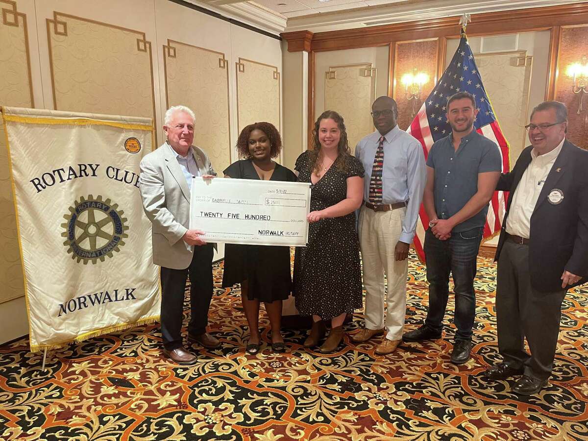 Norwalk High School freshman Gabrielle Tappi (second from left) accepts a check from the Rotary Club of Norwalk to cover her tuition at the Norwalk Conservatory of Arts summer program on May 18. Presenting the check was Norwalk Mayor Harry Rilling, the conservatory's director of operations Julia Orosz, Norwalk High School Principal Reginald Roberts, conservatory president Daniel George, and Rotary vice president Tony Lopez.