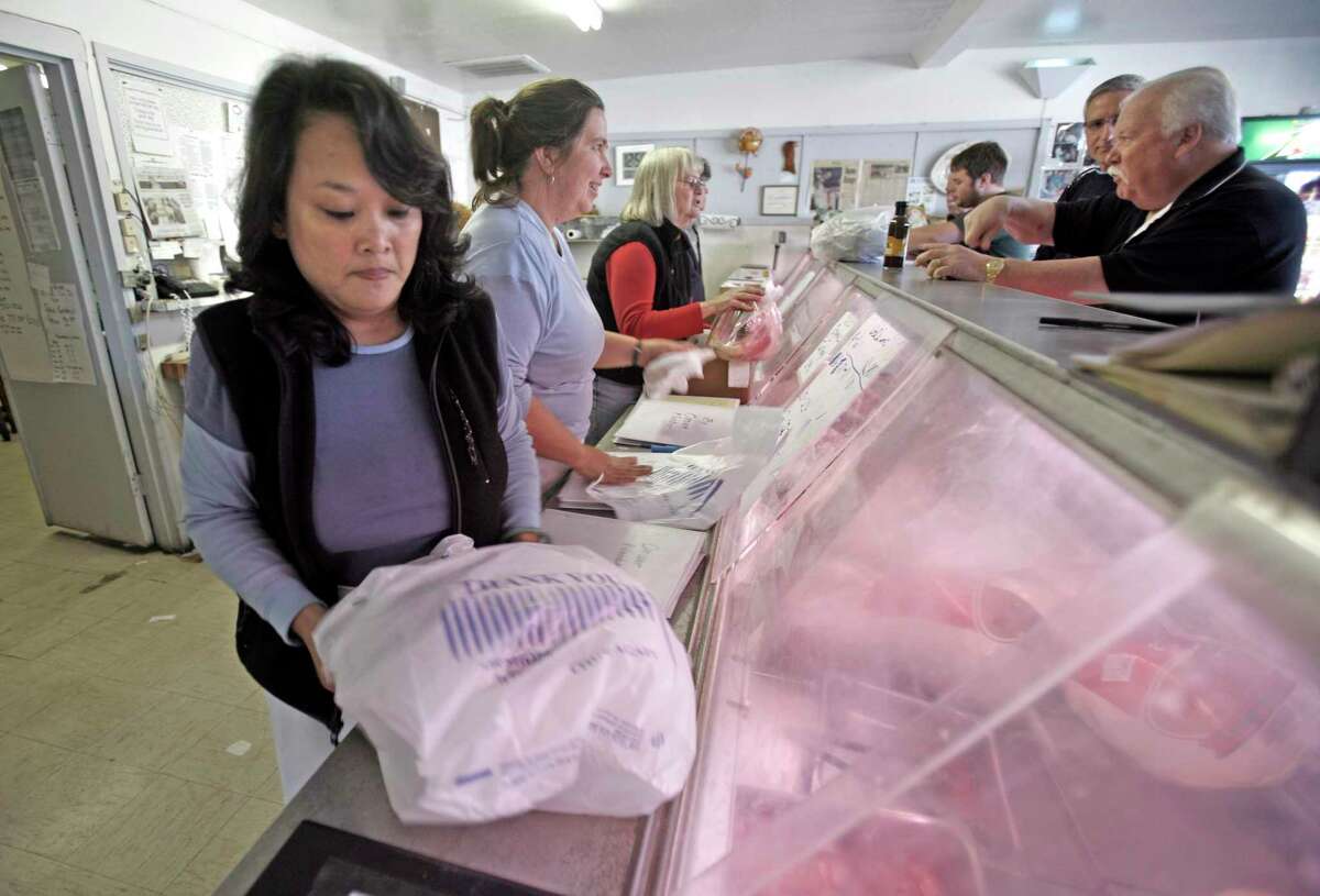 Staffers bag turkeys at Willie Bird in Santa Rosa. The store and deli closed after 47 years, though the brand’s turkeys will continue to be sold elsewhere.