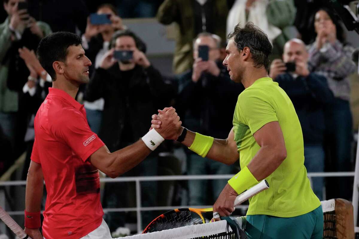 Serbia's Novak Djokovic, left, congratulates Spain's Rafael Nadal who won the quarterfinal match in four sets, 6-2, 4-6, 6-2, 7-6 (7-4), at the French Open tennis tournament in Roland Garros stadium in Paris, France, Wednesday, June 1, 2022.