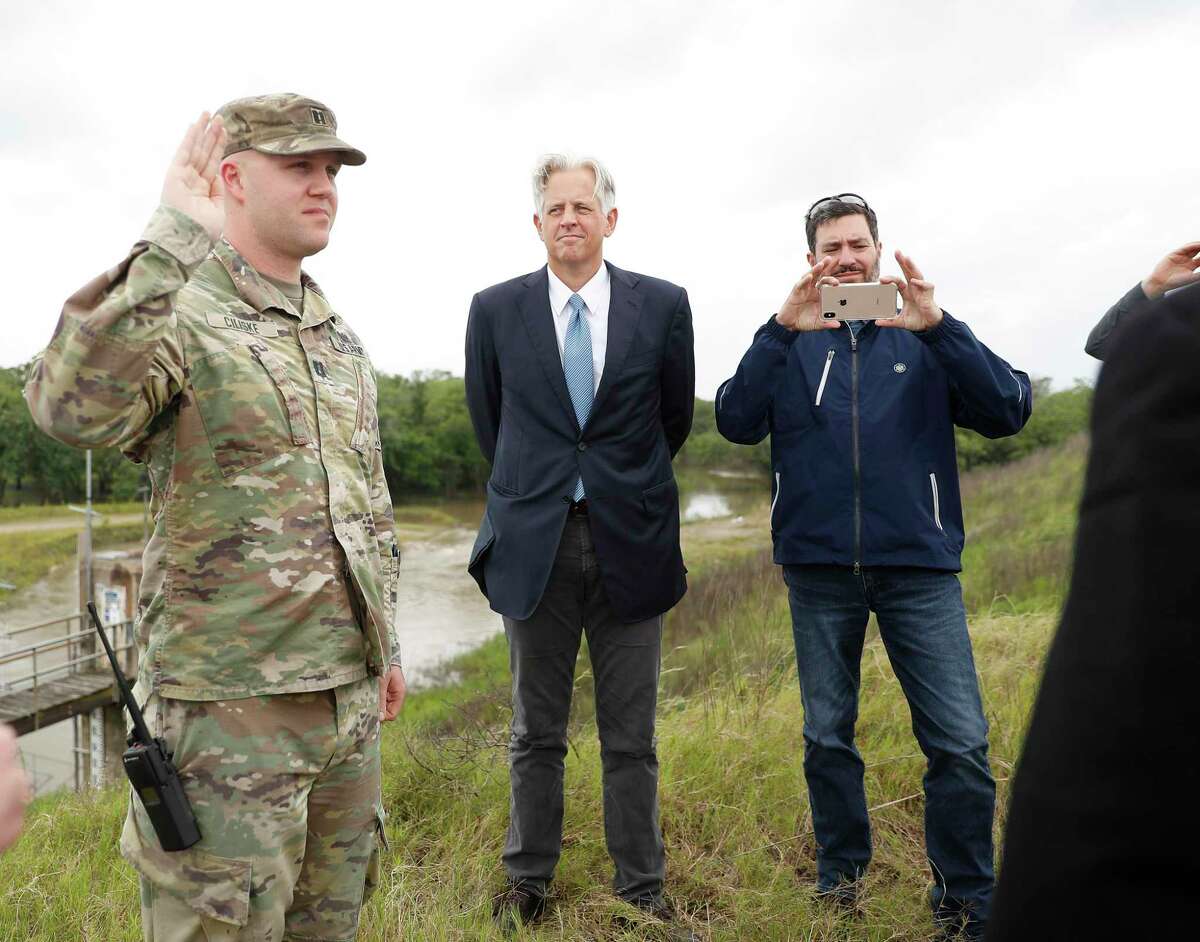 Captain Charles Ciliske with the U.S. Army Corps of Engineers is sworn in by U.S. Judge Charles Lettow on the top of Barker Reservoir in 2019.
