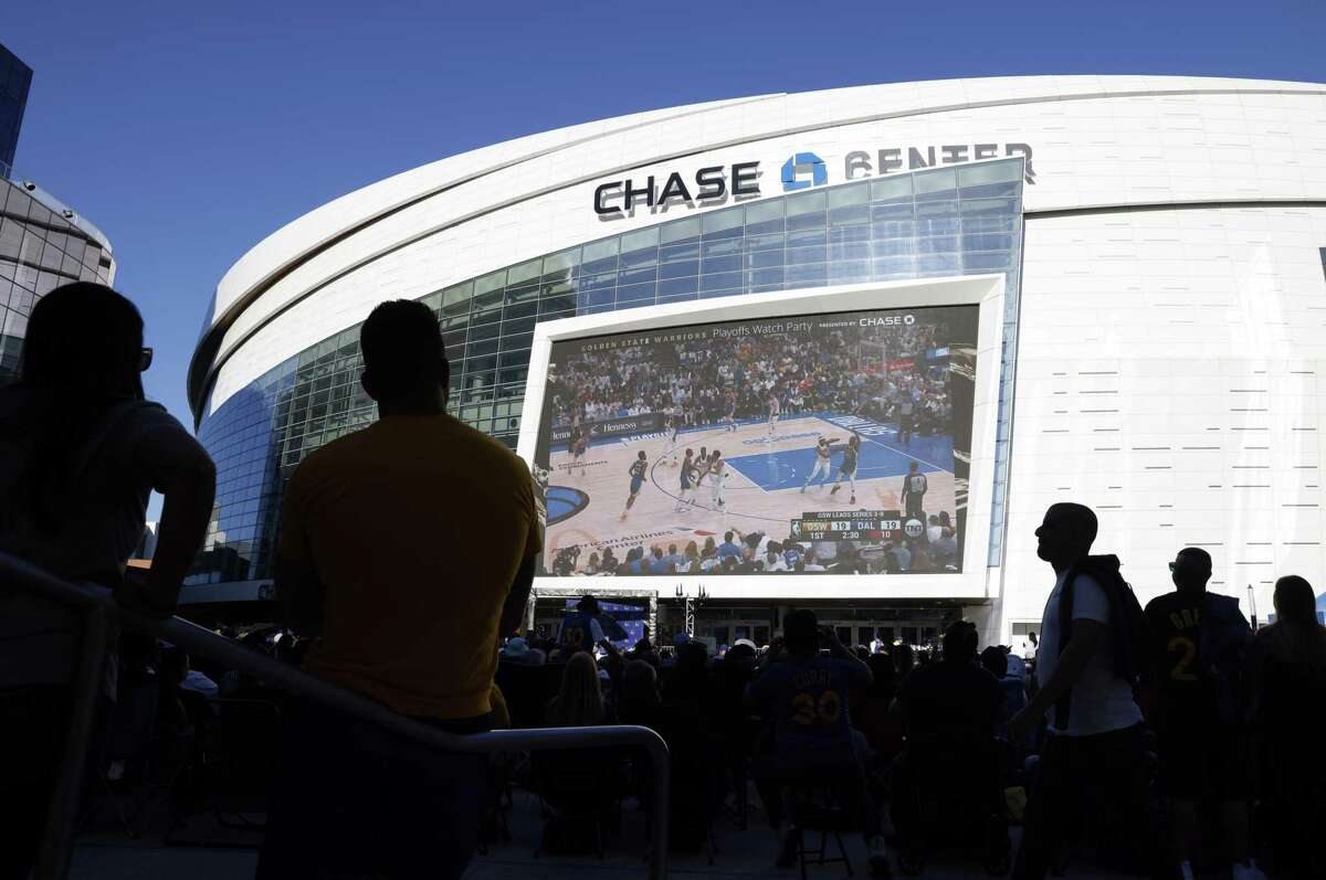 Fans watch on the jumbo screen as the Golden State Warriors played the Dallas Mavericks in Game 4 of the NBA Playoffs Western Conference Finals during a watch party at Chase Center in San Francisco, Calif., on Tuesday, May 24, 2022.