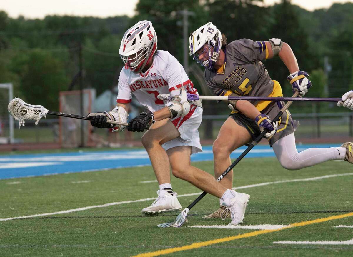 Niskayuna’s Davey Carroll, left, battles with Ballston Spa’s Damien Insogna during the Section II Class B boys' lacrosse final on Tuesday, May 31, 2022 in Latham, N.Y.