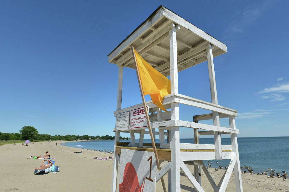 A yellow flag on the lifeguard stand means no lifeguard on duty at Sherwood Island State Park on Tuesday June 19, 2018 in Westport Conn.