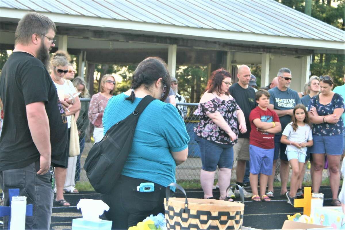Community members gathered at the Morley Stanwood High School football field for a vigil in memory of a slain mother and three children, who were part of the Stanwood community.