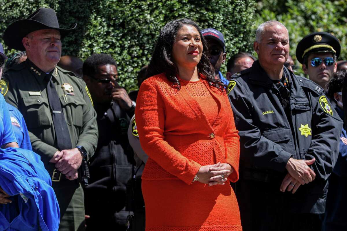 Mayor London Breed stands among law enforcement workers, city ambassadors and other organizations during a press conference announcing her proposed $14 billion budget at Union Square in San Francisco.