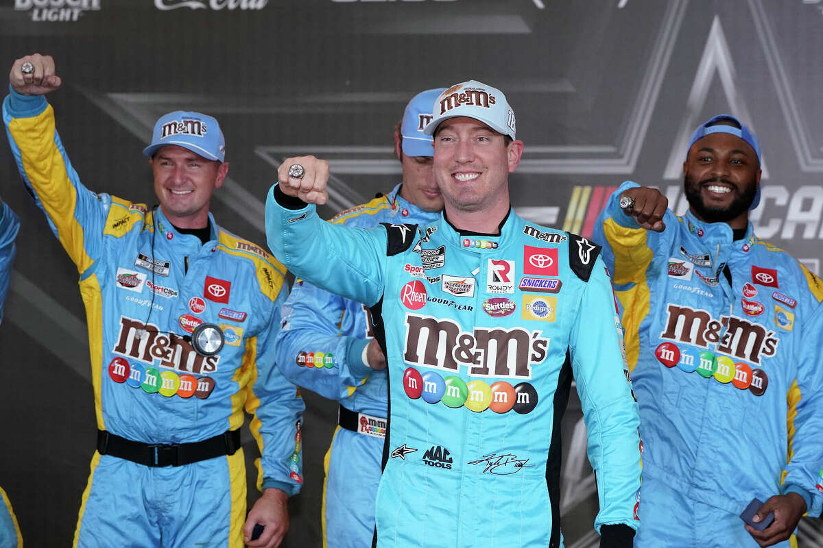 Kyle Busch, front, and his crew show off their pole position rings after qualifications for the NASCAR All-Star Race Saturday in Fort Worth, Texas.