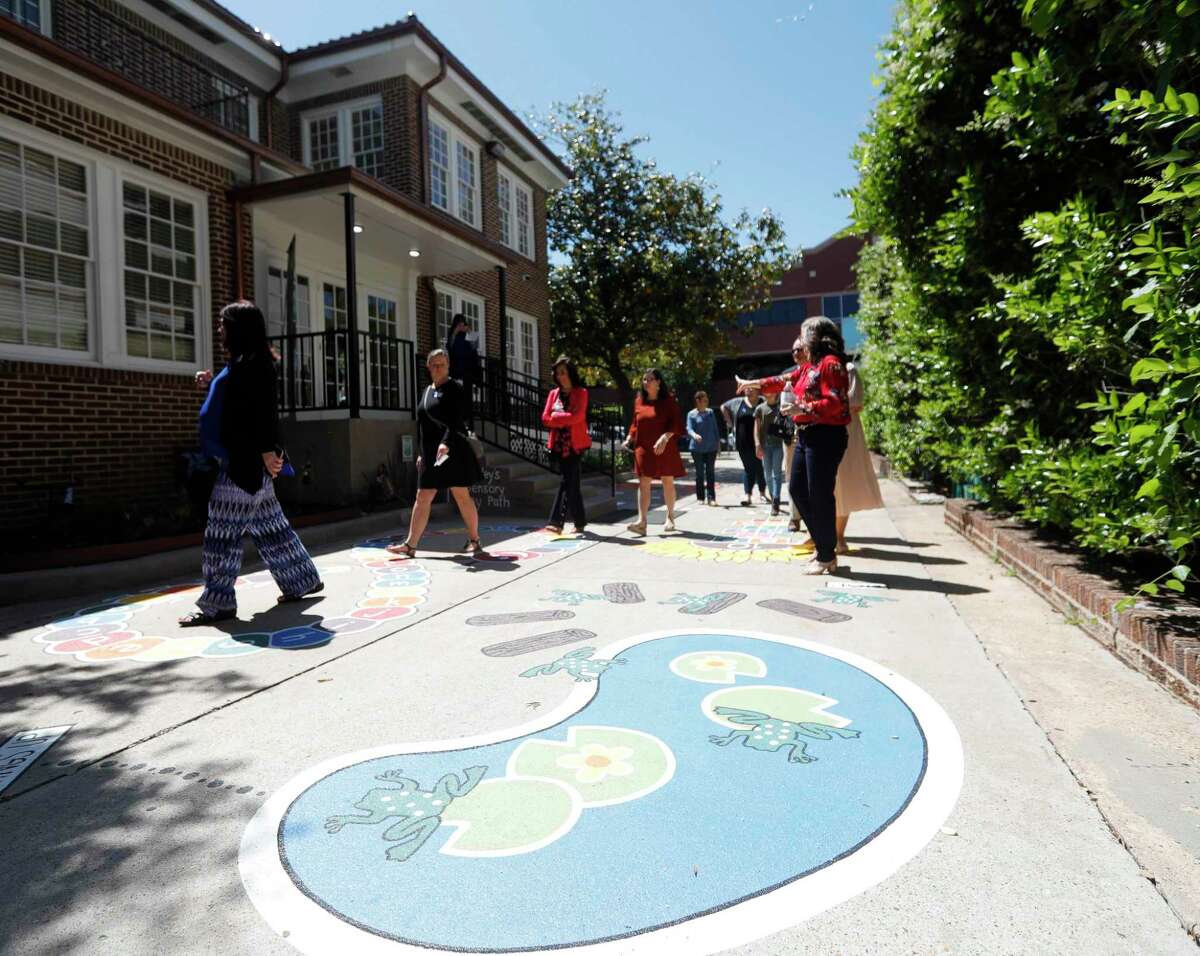 Visitors tour the sensory path at Court Appointed Child Advocates of Montgomery County’s new location on North Main Street, Wednesday, April 27, 2022, in Conroe.