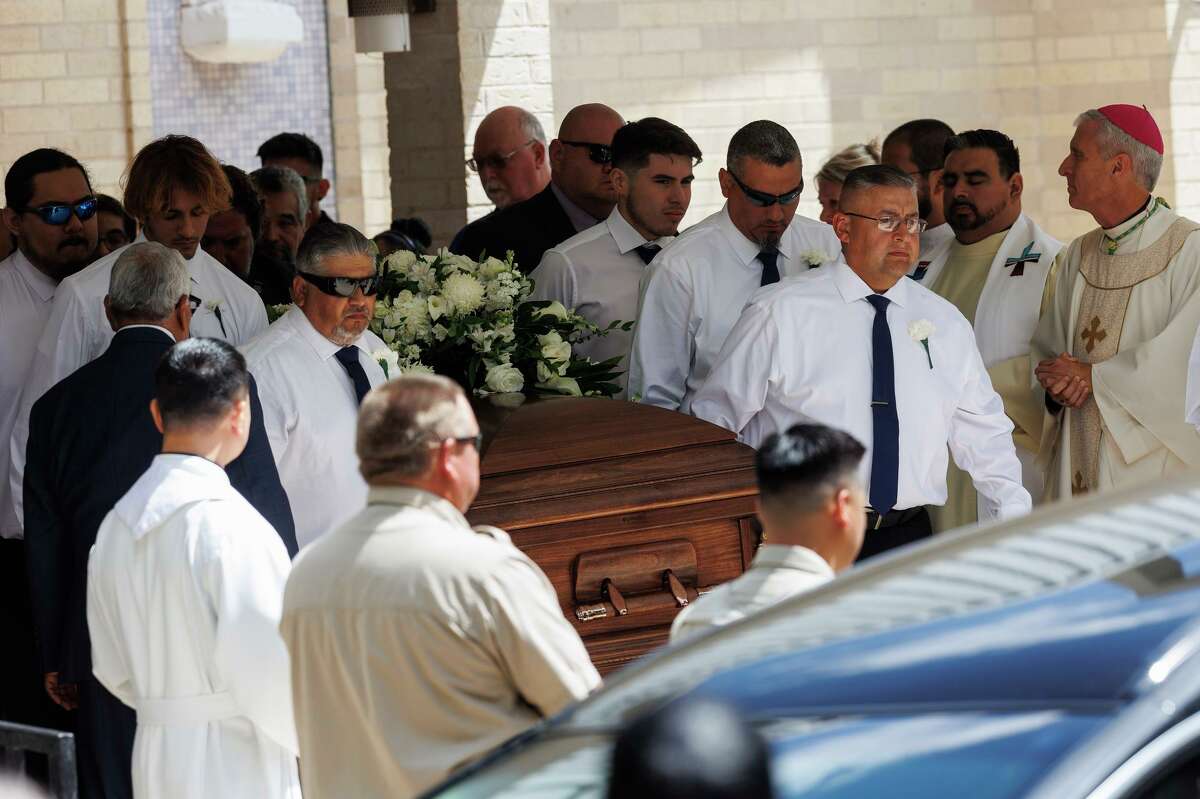 Pallbearers carry one of the coffins out of Sacred Heart Catholic Church at the end of a joint funeral service for Irma Linda Garcia, 48, and her husband Jose Antonio “Joe” Garcia, 50, in Uvalde on Wednesday. Irma, a, fourth grade teacher at Robb Elementary, was killed in her classroom during the May 24 mass shooting. Her husband of 24 years died a couple days later of a heart attack.