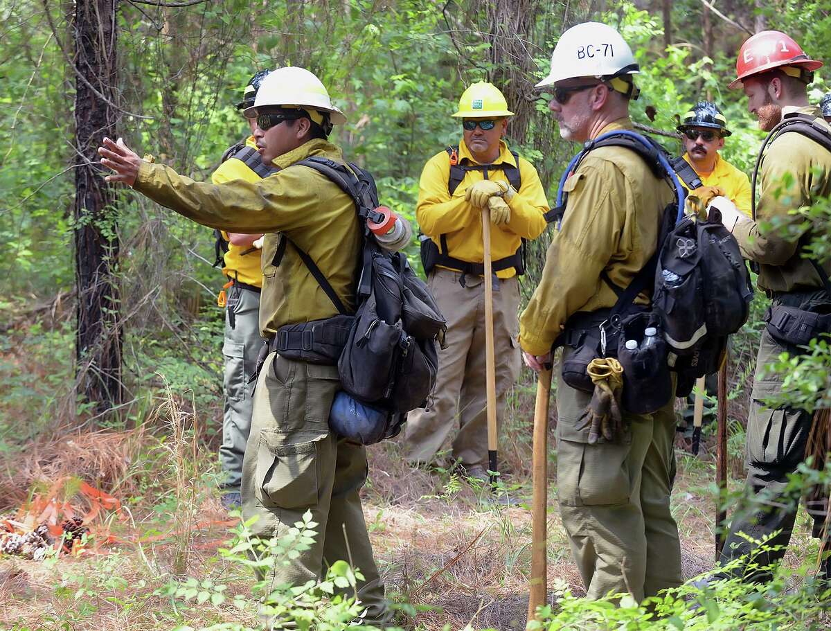 Instructors with the Texas A&M Forest Service explain firefighting techniques at the 2022 East Texas Interagency Wildfire and Incident Management Academy.