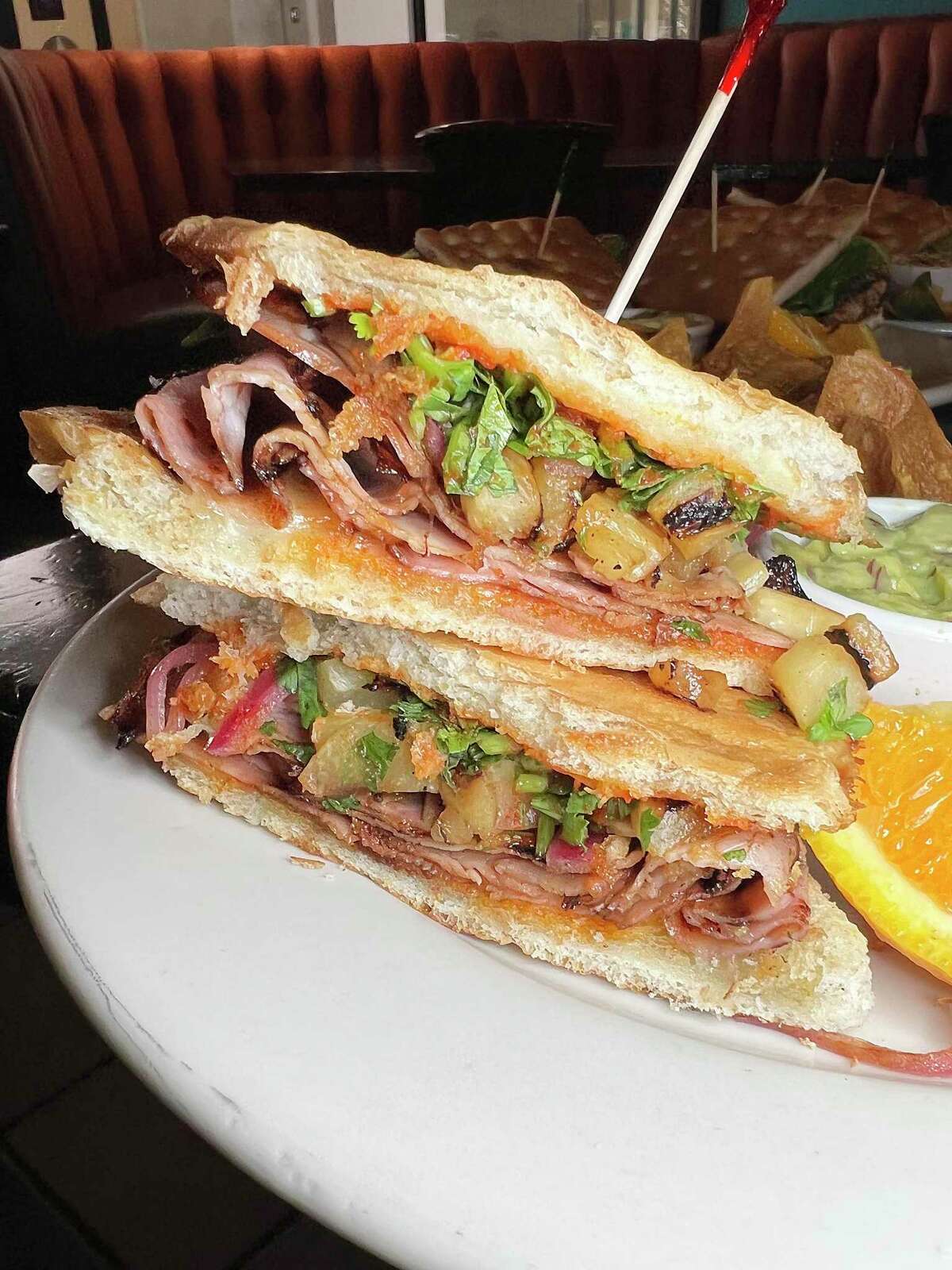 The Spicy Hawaiian sandwich includes grilled ham, pineapple, provolone cheese, cilantro and Sriracha on a bolillo roll at Pam’s Patio Kitchen and Wine Bar.