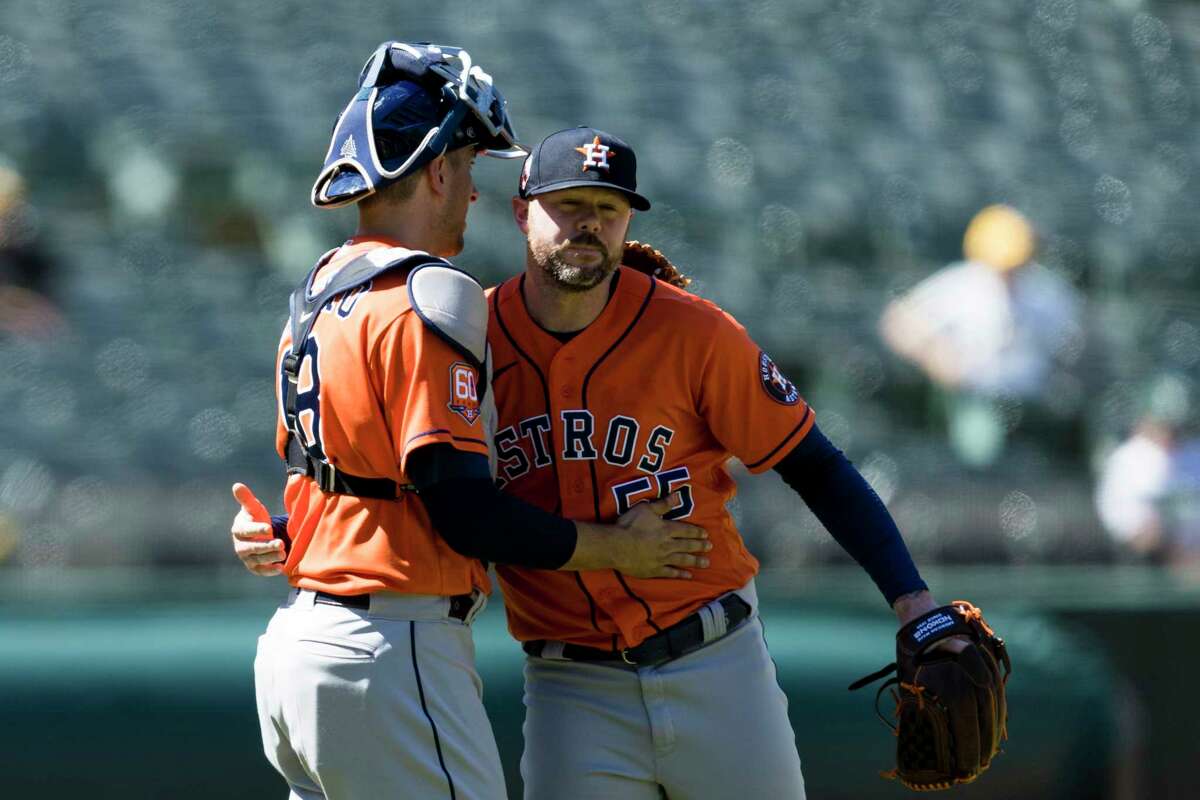 Houston Astros closing pitcher Ryan Pressly, right, celebrates with Jason Castro after defeating the Oakland Athletics in a baseball game in Oakland, Calif., Wednesday, June 1, 2022. The Astros won 5-4. (AP Photo/John Hefti)
