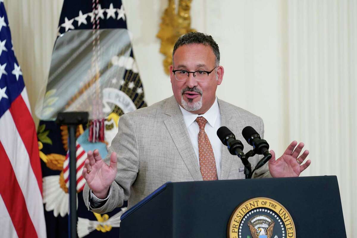 In this file photo, Education Secretary Miguel Cardona speaks during the 2022 National and State Teachers of the Year event in the East Room of the White House in Washington, April 27, 2022. The Biden administration has announced it will forgive all remaining federal student debt for former students of the for-profit Corinthian Colleges chain.