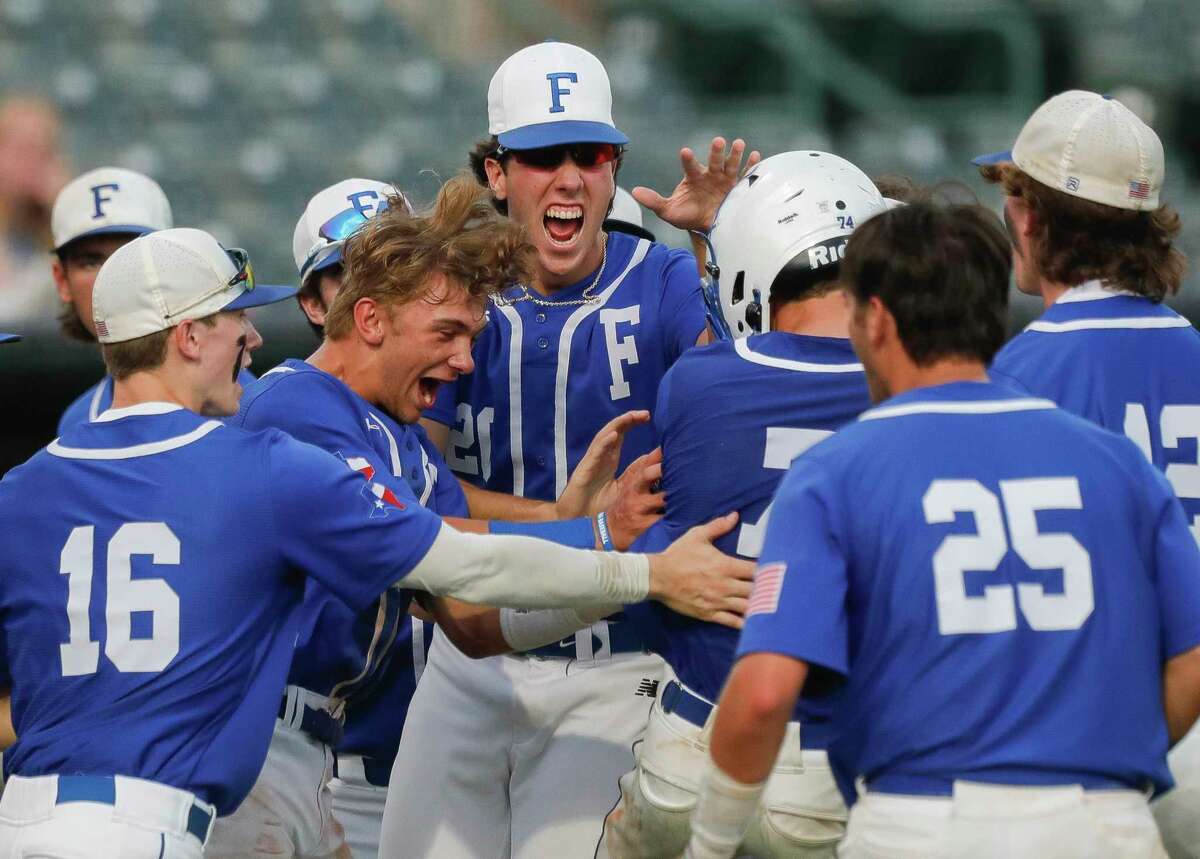 Friendswood players celebrate after Colin Goolsby scored on a balk by Lake Creek starting pitcher Shane Sdao in the fourth inning of Game 1 during the Region III-5A high school baseball championship series at Rice University, Wednesday, June 1, 2022, in Houston. Friendswood scored four runs in the inning to take a 4-1 lead.