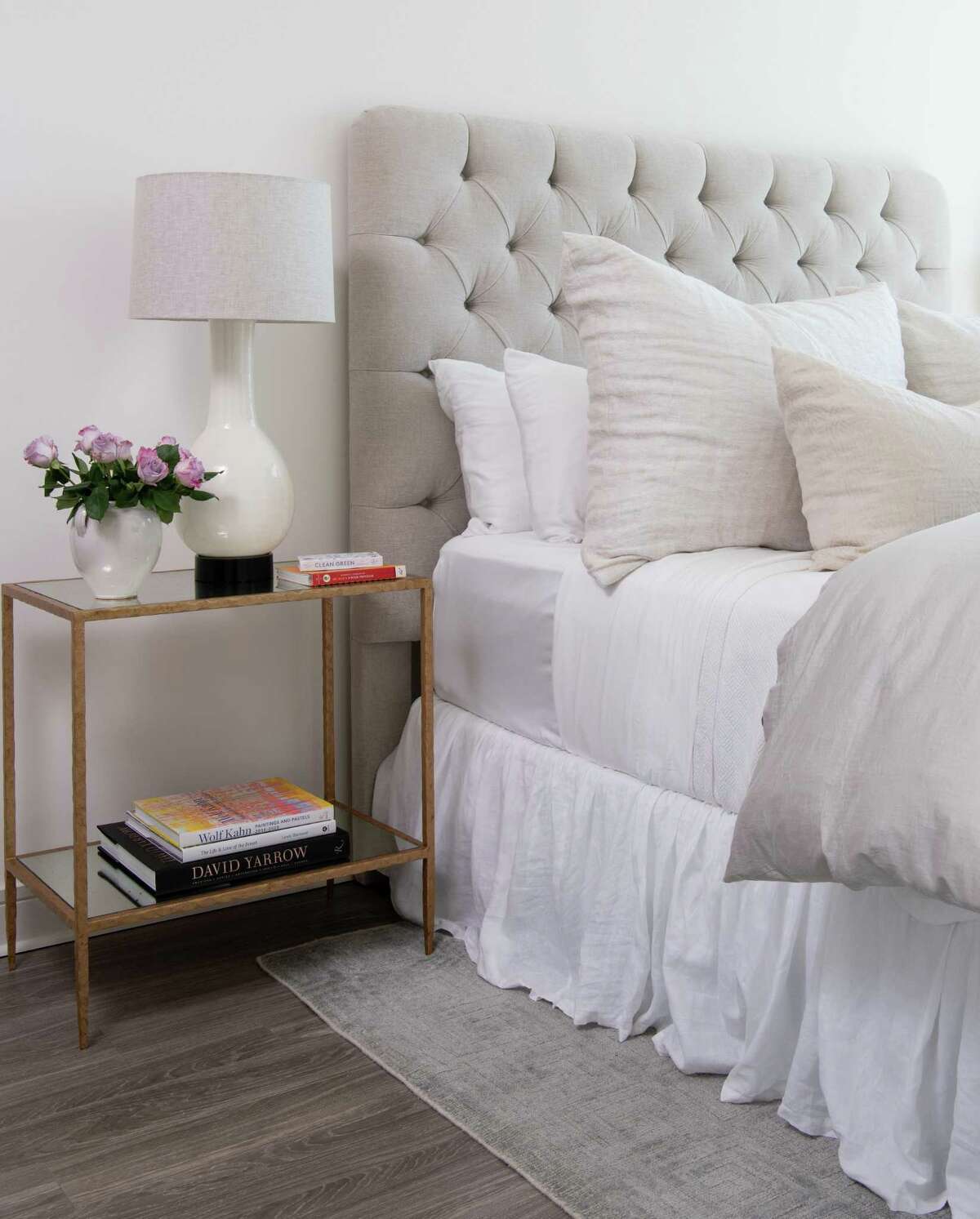 A chenille tufted headboard and soft bedding sets a luxurious tone in the primary bedroom.