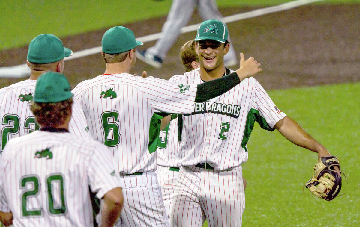 Alton River Dragons reliever Noah Bush (2) is greeted by starter Adam Stilts (6) after closing Wednesday night's 6-5 season-opening victory over the Springfield Lucky Horseshoes at Lloyd Hopkins Field.