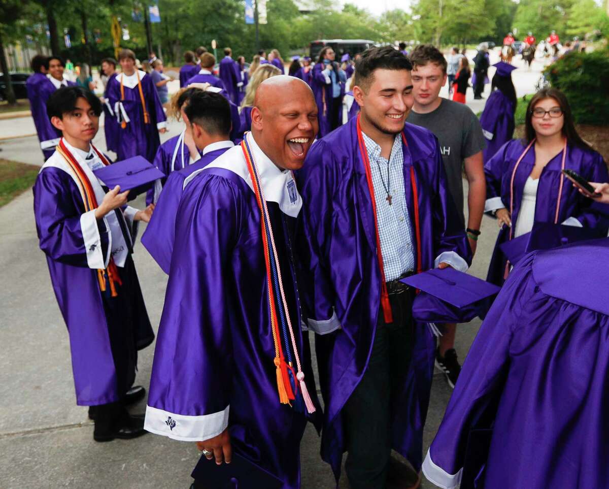Willis High School senior Avery Willis, center, laughs with friends before a graduation ceremony at at Cynthia Woods Mitchell Pavilion, Wednesday, June 1, 2022, in The Woodlands.